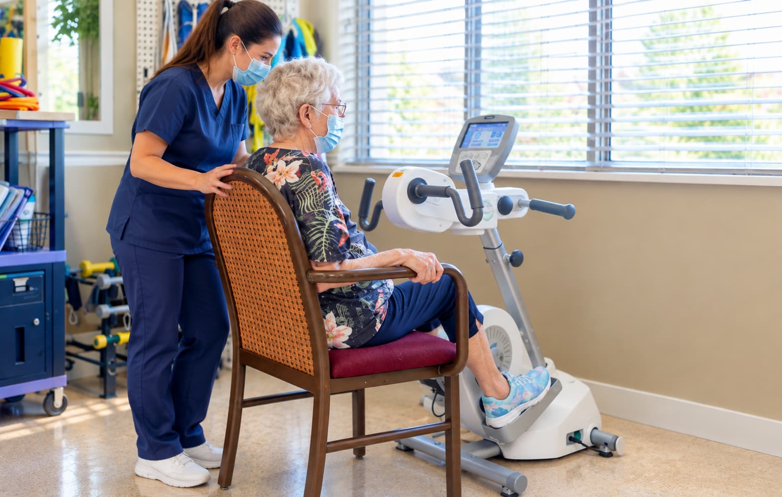 A staff member setting a resident up on a therapy cycle