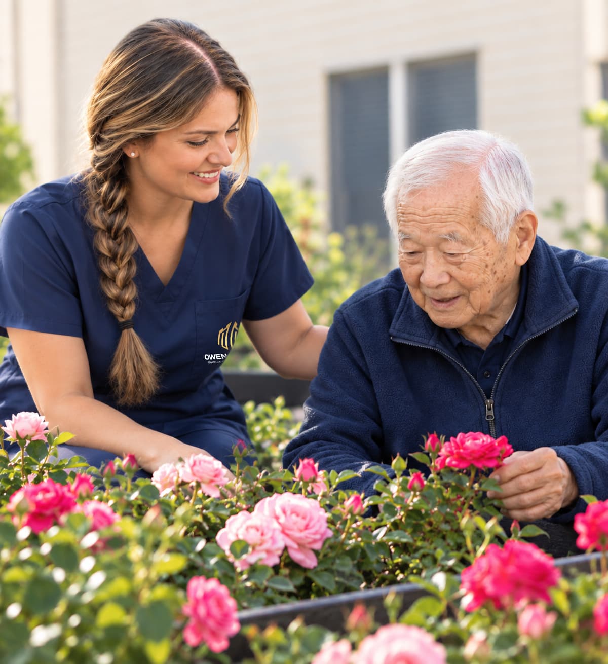 A caregiver and a resident tending roses together