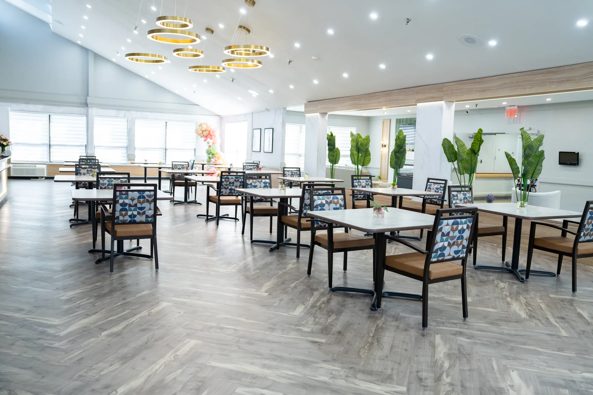 The main dining room, tables set beneath hanging lights