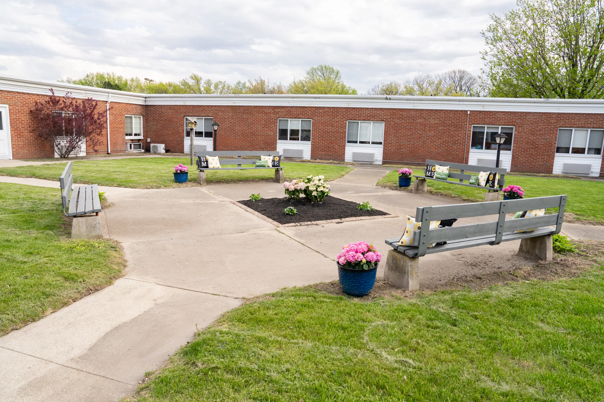 The courtyard, with benches and planted beds along the path