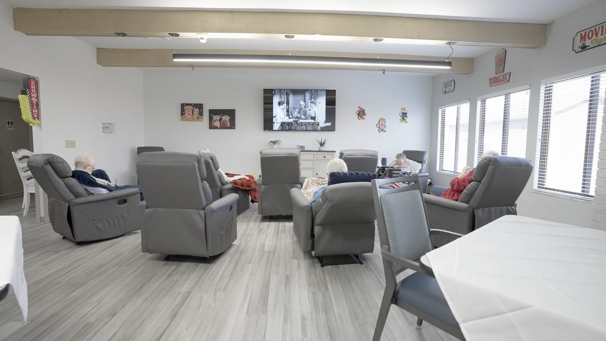 The lounge, recliners grouped in front of a wall-mounted television