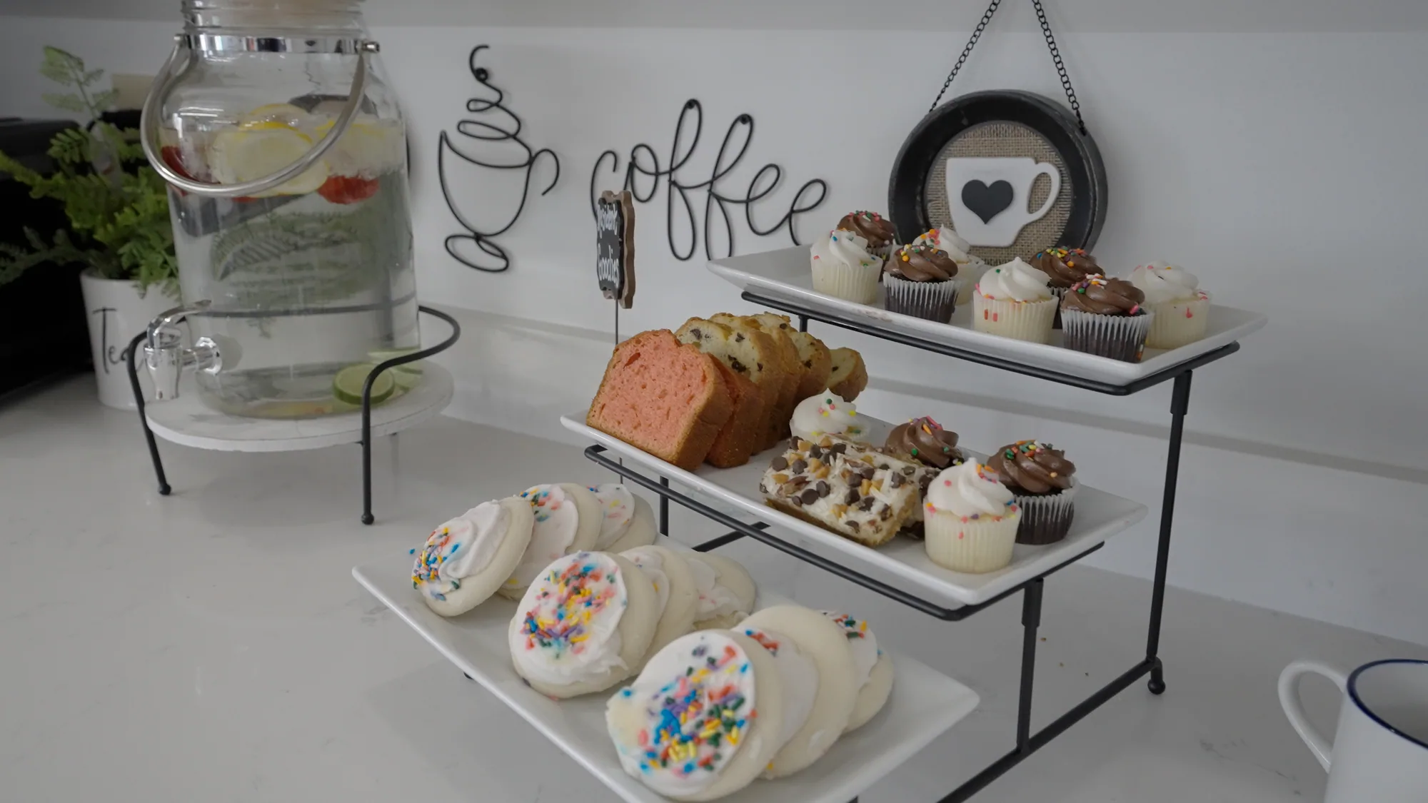 A tiered stand of pastries and cookies at the coffee station