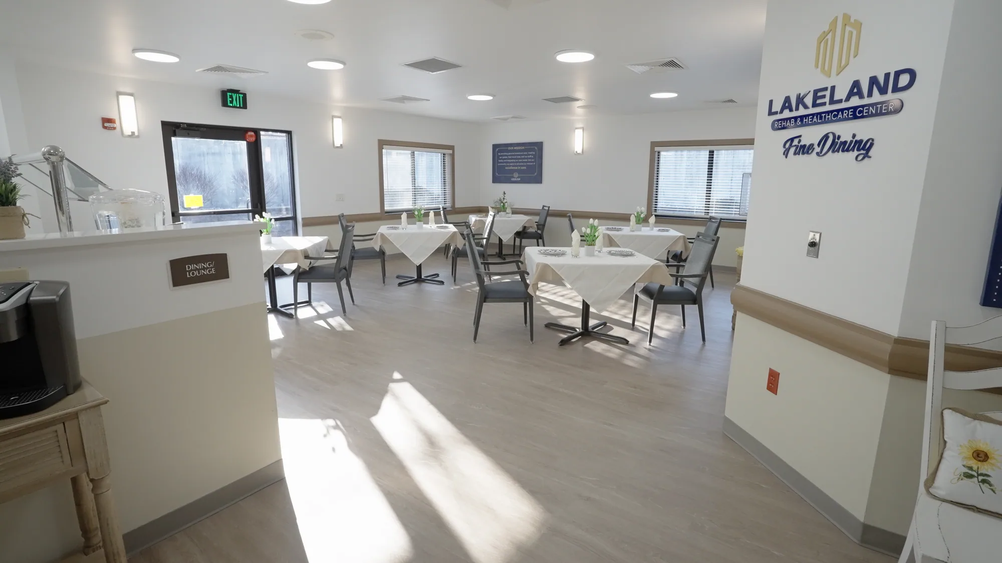 The Fine Dining room, tables set beneath tall windows